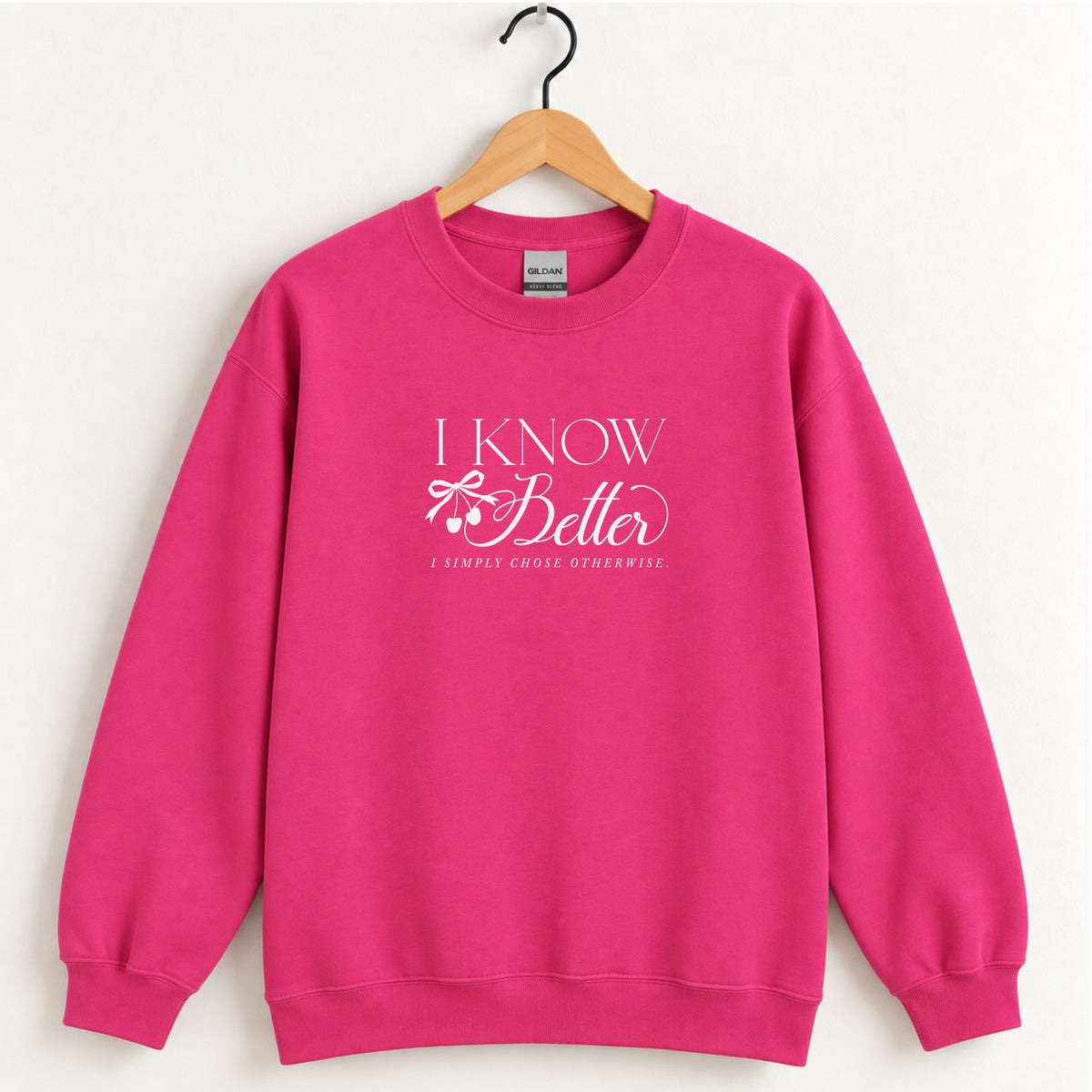 I Know Better, I Simply Chose Otherwise crewneck sweatshirt in Heliconia pink on a wooden hanger