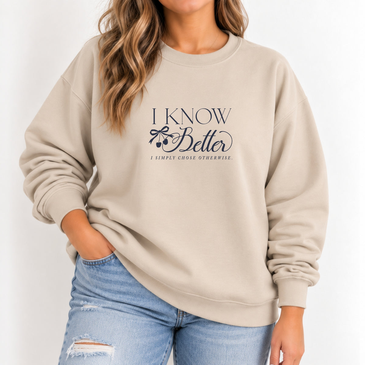 Woman wearing the I Know Better, I Simply Chose Otherwise crewneck in Sand with a navy chest print