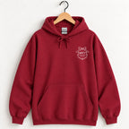 Raised Better Than This crest hoodie in Cardinal Red on a wooden hanger