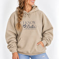 Woman wearing the I Know Better, I Simply Chose Otherwise hoodie in Sand with a navy chest print