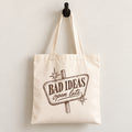 Bad Ideas, Open Late canvas tote bag hanging on a wall hook, retro sign printed in brown