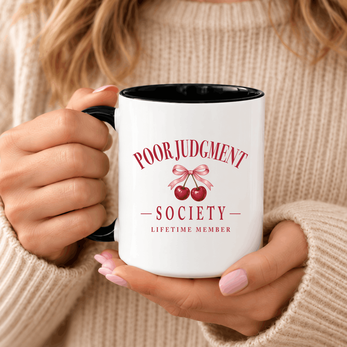 Woman in a knit sweater holding the Poor Judgment Society Lifetime Member mug in Black