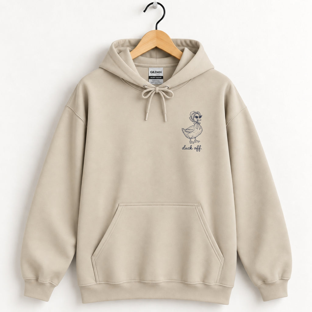 Duck Off hoodie in Sand on a wooden hanger, small navy duck on the left chest