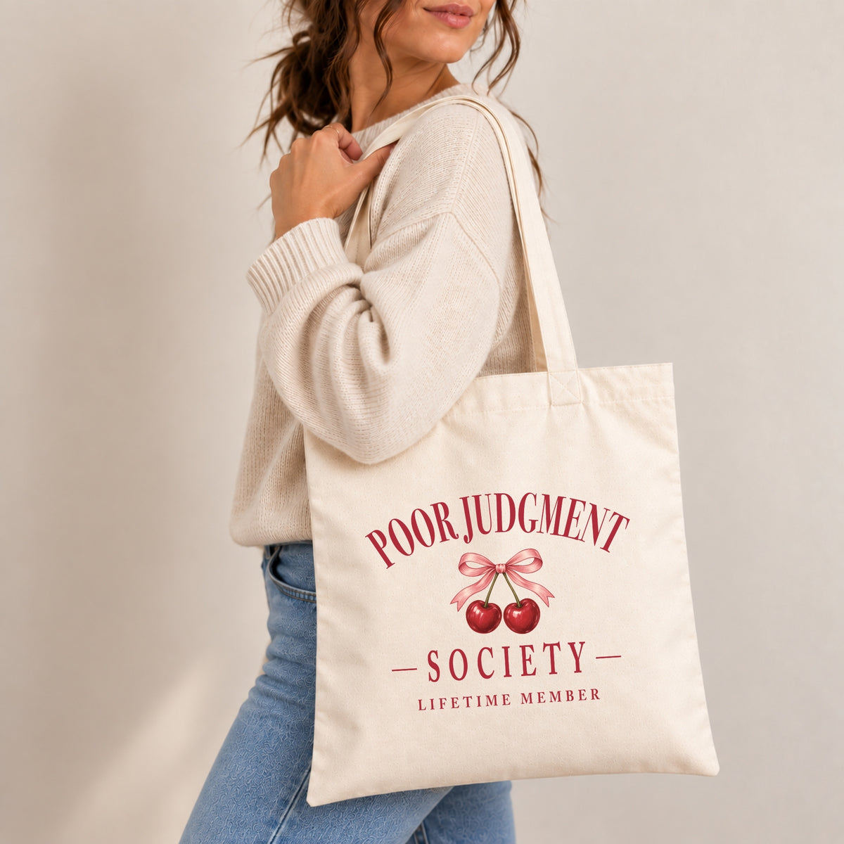 Woman carrying the Poor Judgment Society Lifetime Member canvas tote on her shoulder