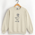 Duck Off crewneck sweatshirt in Sand on a wooden hanger, navy duck in a bonnet and sunglasses printed center chest