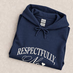 Respectfully, No hoodie in Navy folded on a cream floral surface, chest design close up
