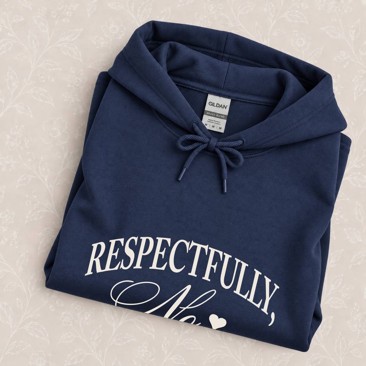 Respectfully, No hoodie in Navy folded on a cream floral surface, chest design close up