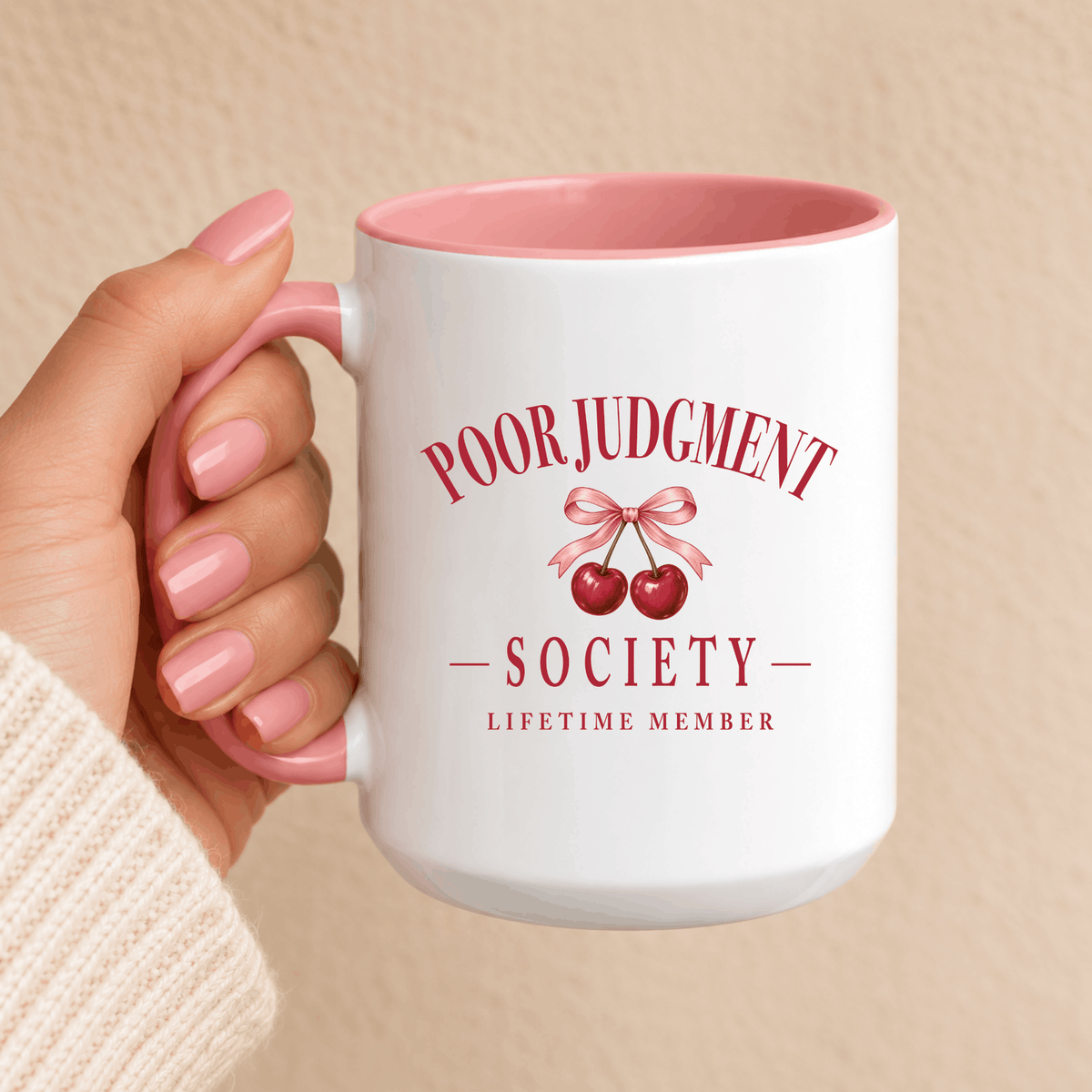 Poor Judgment Society Lifetime Member mug in Pink, held in hand, vintage cherry bow crest
