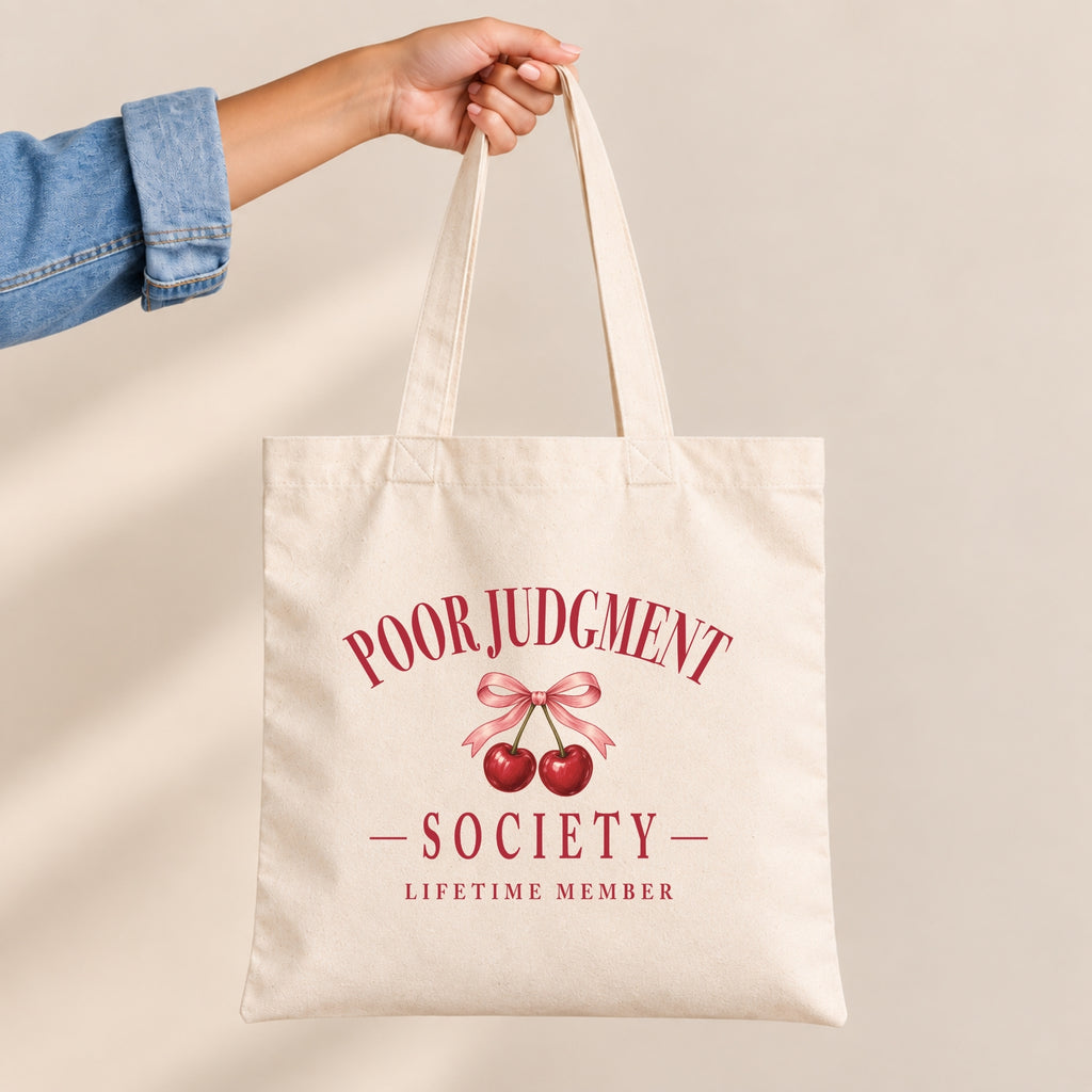 Poor Judgment Society Lifetime Member canvas tote bag held by the handles