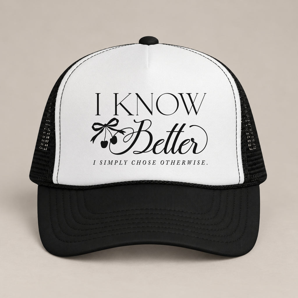I Know Better, I Simply Chose Otherwise foam trucker hat in Black, front view, black script and cherry bow on a white panel