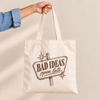 Bad Ideas, Open Late canvas tote bag held by the handles