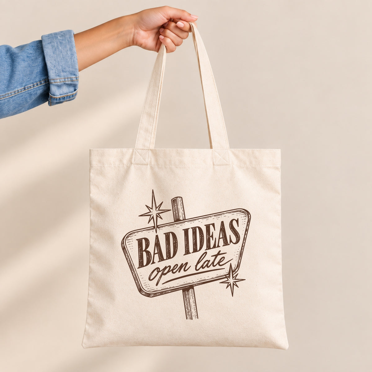 Bad Ideas, Open Late canvas tote bag held by the handles