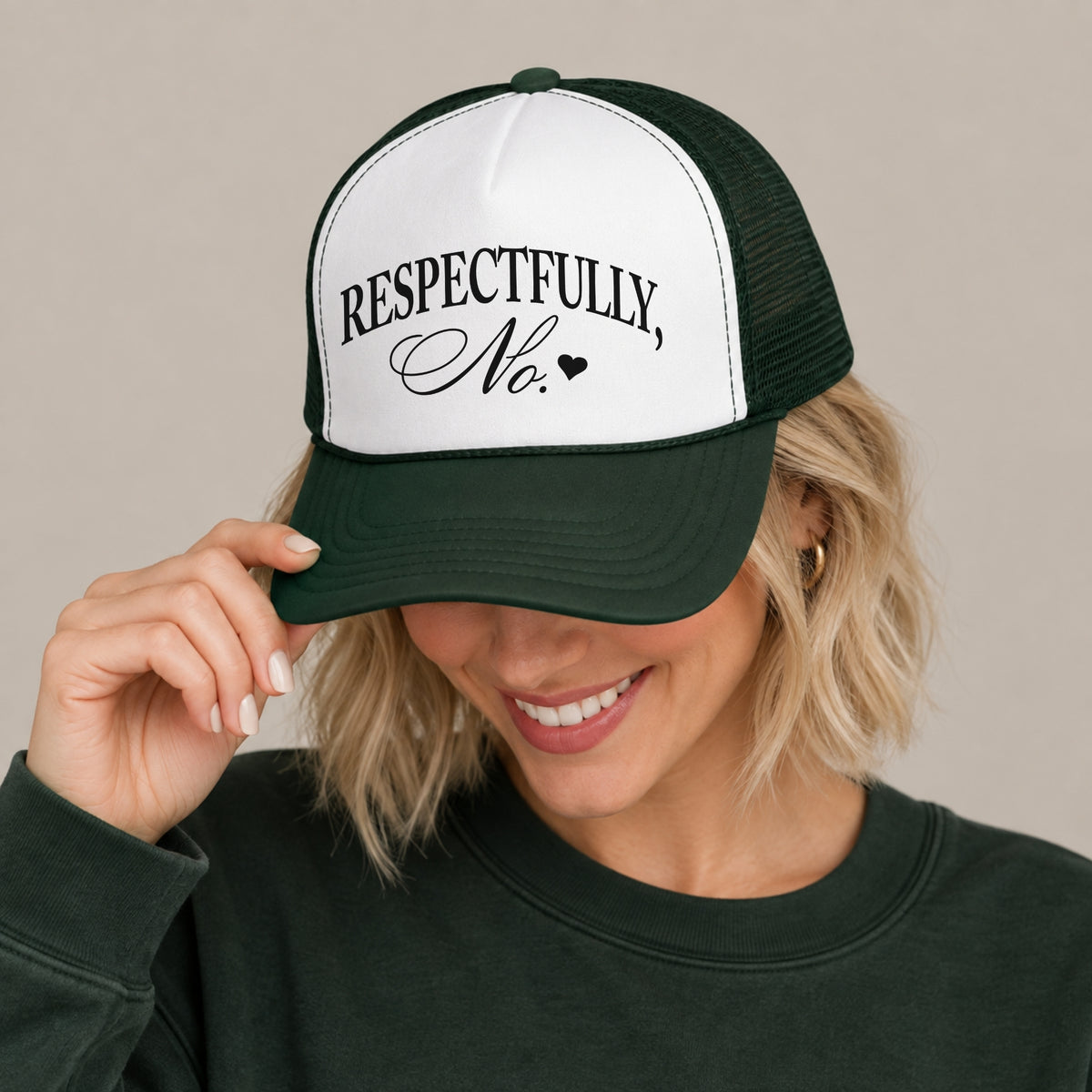 Woman in a dark green sweatshirt wearing the Respectfully, No trucker hat in Dark Green with a white front panel