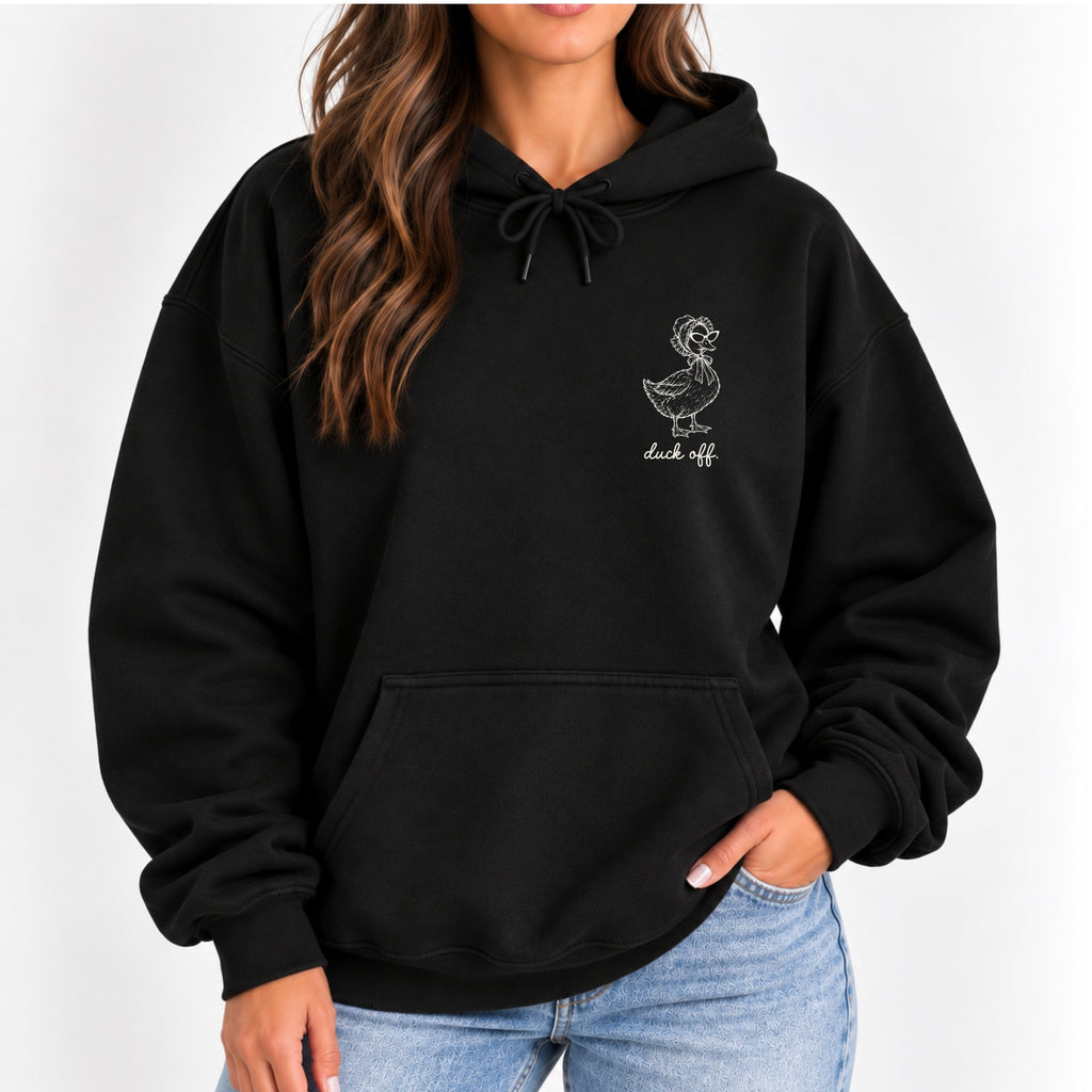 Woman wearing the Duck Off hoodie in Black, left-chest white duck design