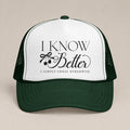 I Know Better, I Simply Chose Otherwise foam trucker hat in Dark Green, front view, black script and cherry bow on a white panel