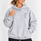 Woman wearing the Duck Off hoodie in Ash, left-chest navy duck design