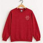 Raised Better Than This crest crewneck sweatshirt in Cardinal Red on a wooden hanger