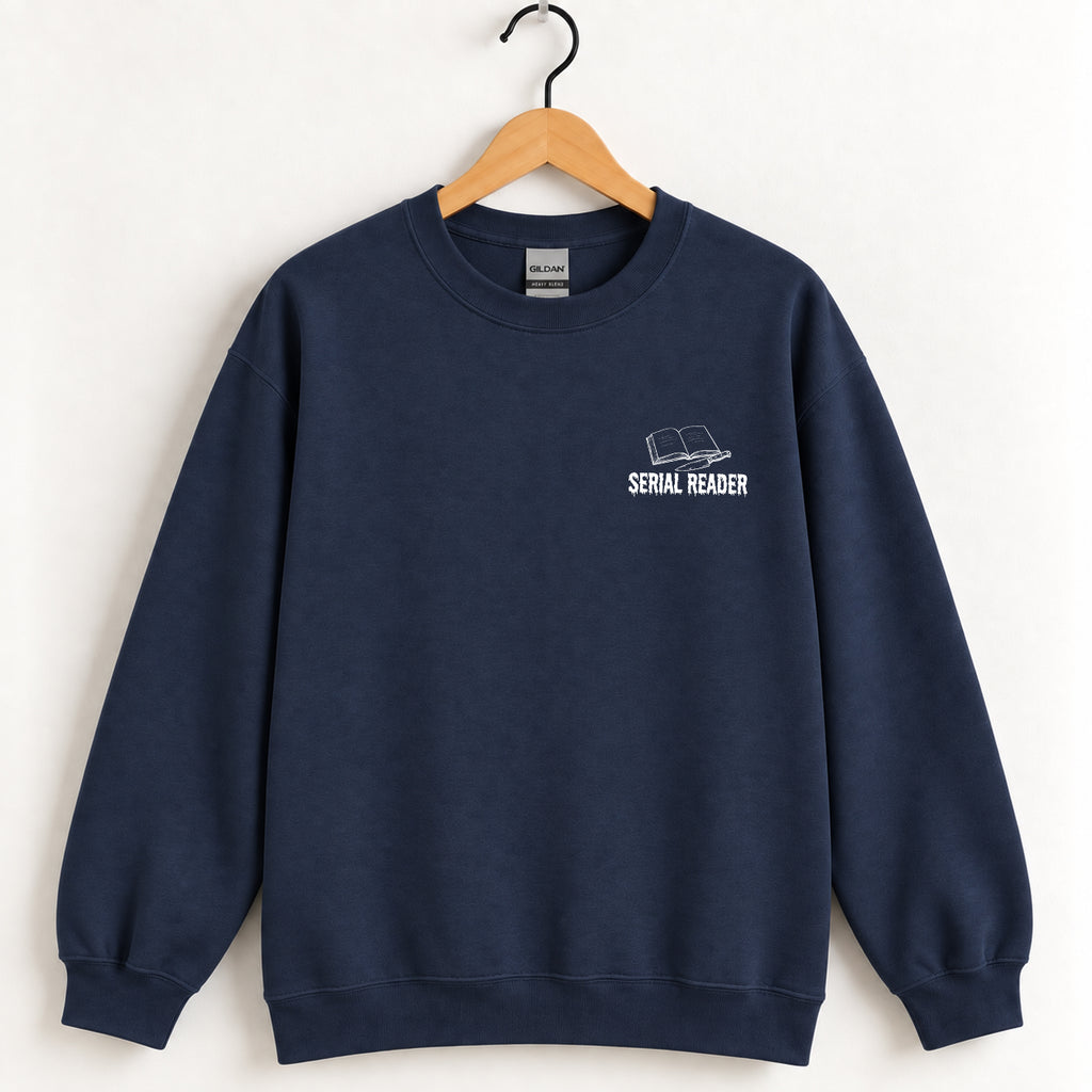 Serial Reader crewneck sweatshirt in Navy on a wooden hanger, white left-chest book and knife design