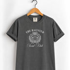 The Haunted Social Club tee in Pepper on a wooden hanger