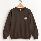 Rock On Skeleton Hand embroidered crewneck sweatshirt in Dark Chocolate on a wooden hanger