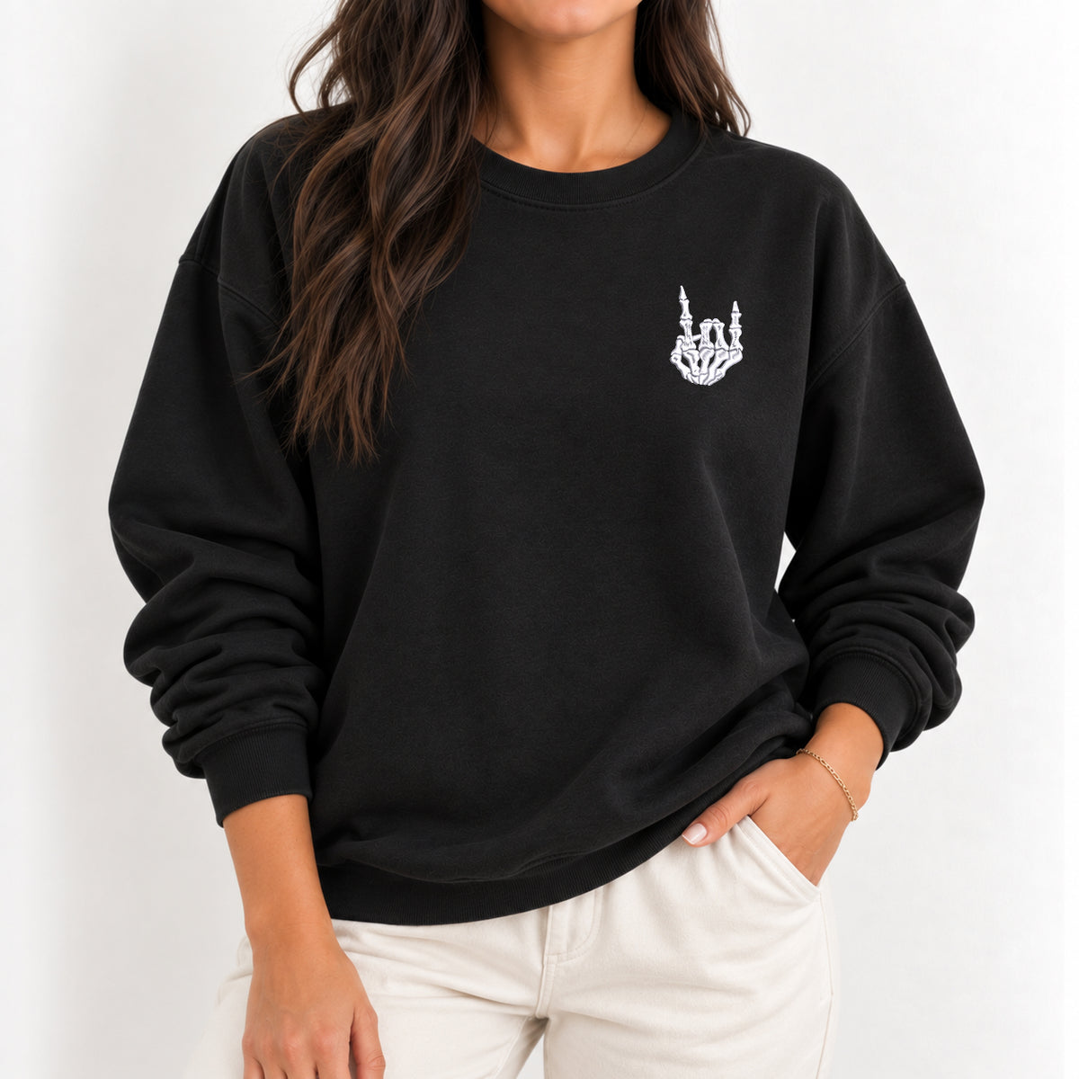 Woman wearing the Rock On Skeleton Hand embroidered crewneck sweatshirt in Black with jeans