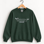 Spooky Season embroidered crewneck sweatshirt in Forest Green on a wooden hanger