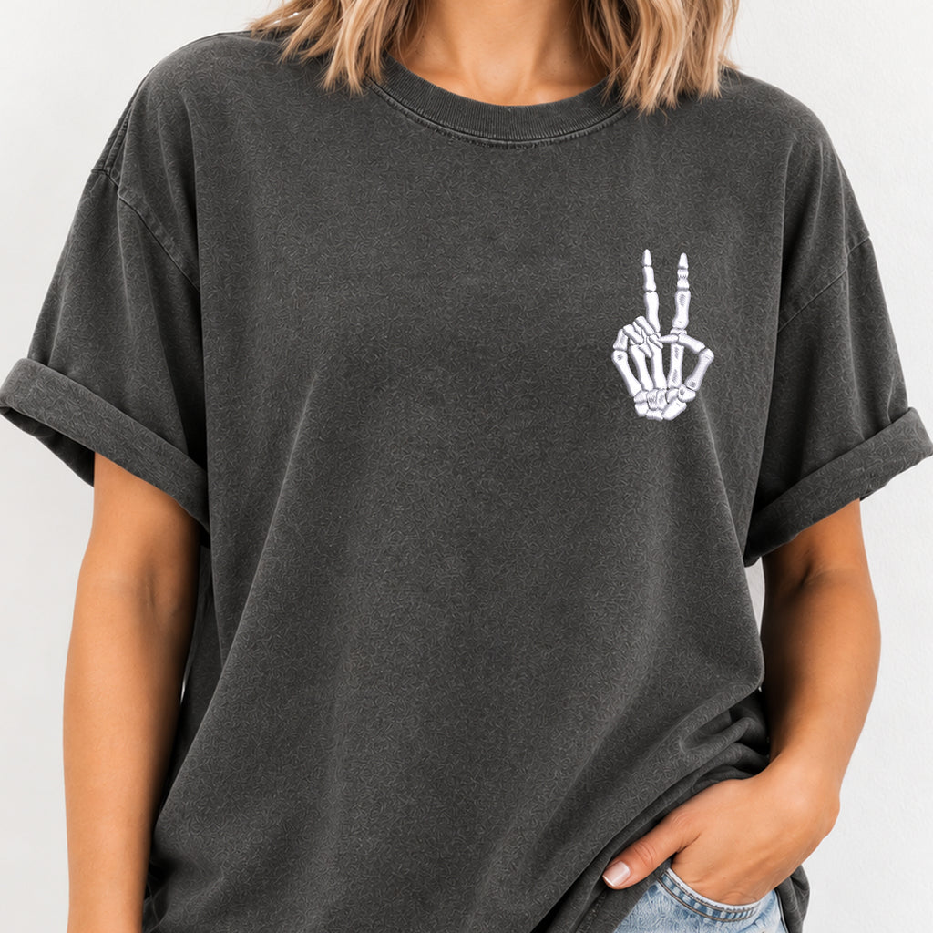 Woman wearing the peace sign skeleton hand embroidered tee in Pepper
