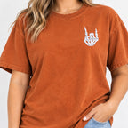 Woman wearing the rock on skeleton hand embroidered tee in Yam