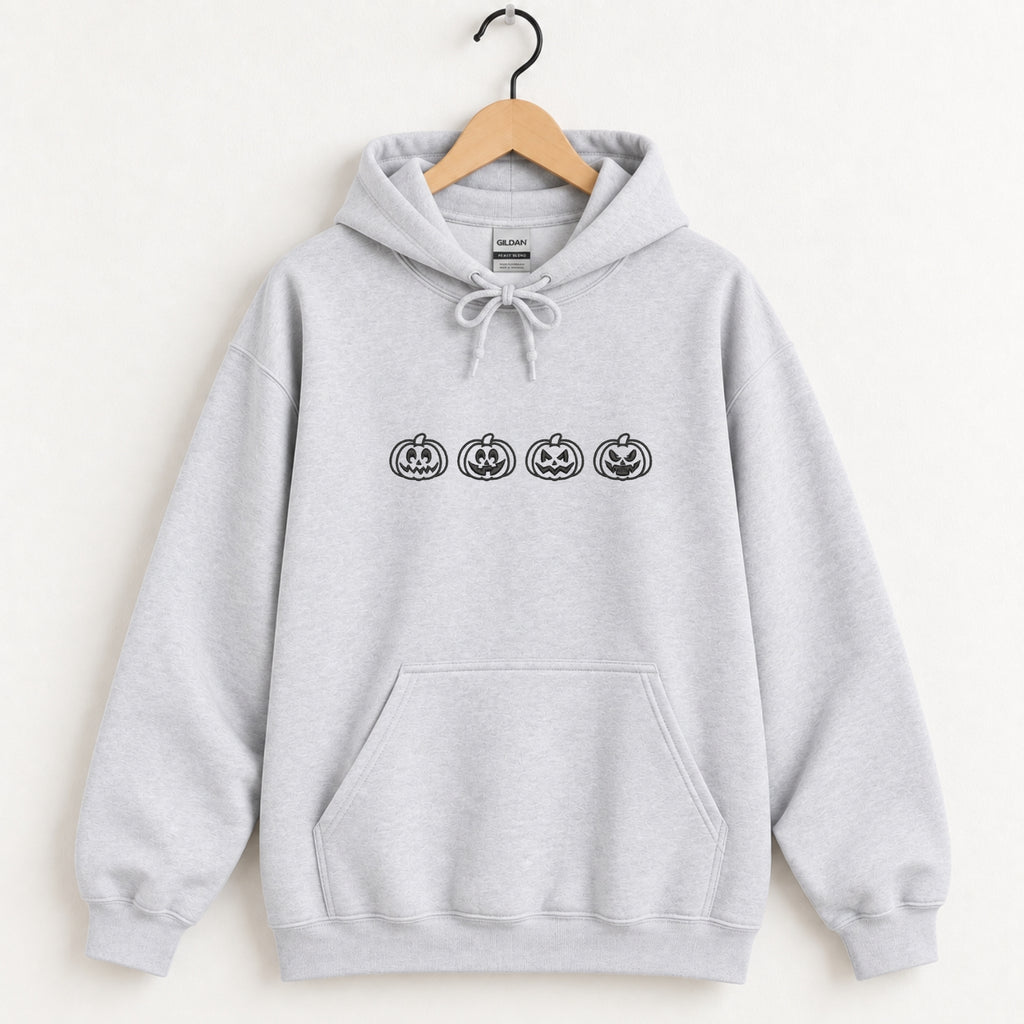 Jack-o-lantern embroidered hoodie in Ash on a wooden hanger, black thread pumpkins