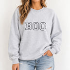 Woman wearing the Boo embroidered crewneck sweatshirt in Ash with jeans