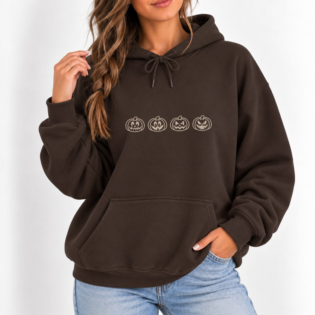 Woman wearing the Jack-o-lantern embroidered hoodie in Dark Chocolate with jeans, ivory thread pumpkins