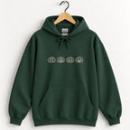 Jack-o-lantern embroidered hoodie in Forest Green on a wooden hanger, ivory thread pumpkins