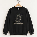 Here for the Boos crewneck sweatshirt in Black on a wooden hanger, ivory ghost with a martini on the chest
