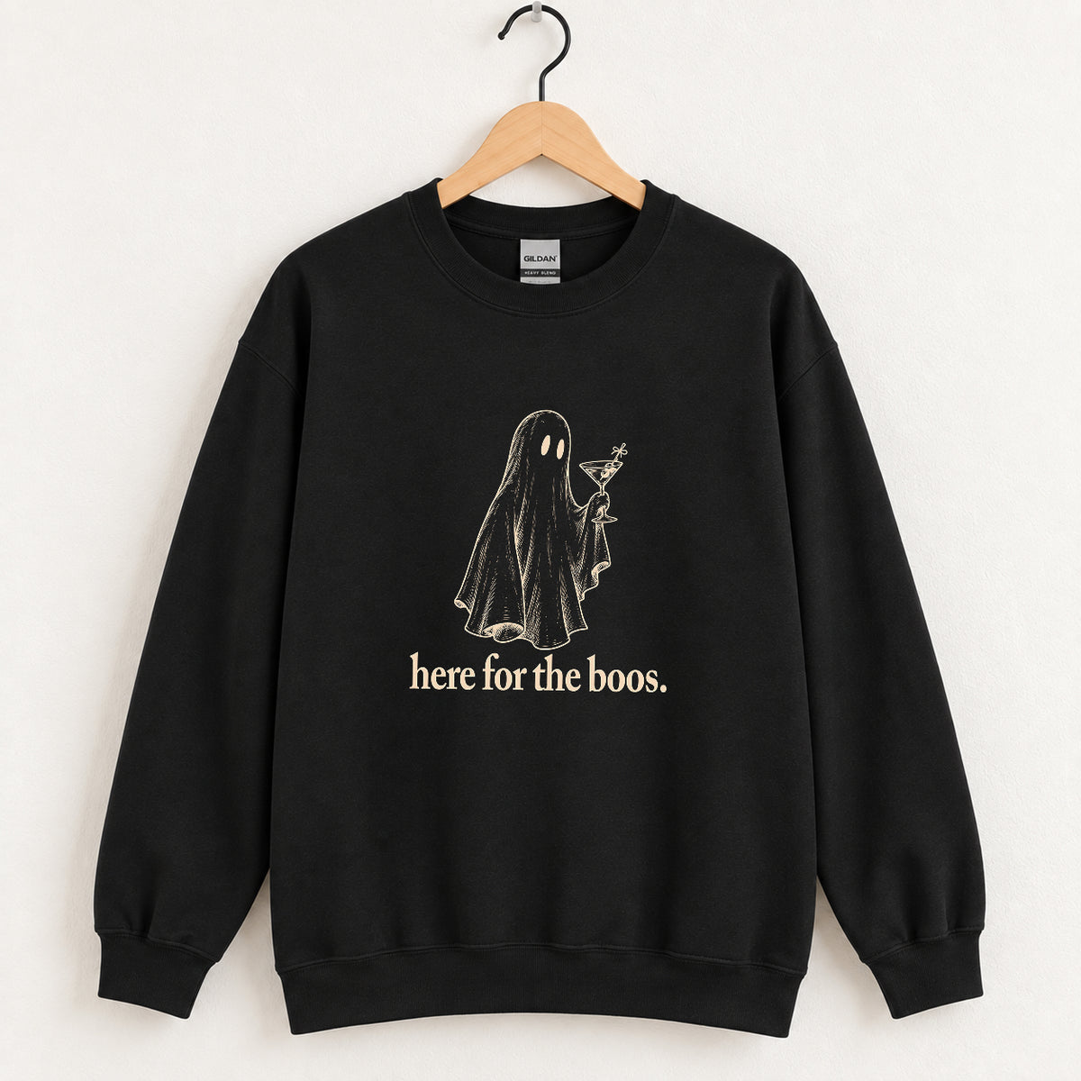 Here for the Boos crewneck sweatshirt in Black on a wooden hanger, ivory ghost with a martini on the chest