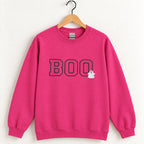 Boo embroidered crewneck sweatshirt in Heliconia pink on a wooden hanger