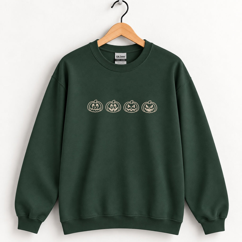 Jack-o-lantern embroidered crewneck sweatshirt in Forest Green on a wooden hanger