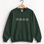 Jack-o-lantern embroidered crewneck sweatshirt in Forest Green on a wooden hanger