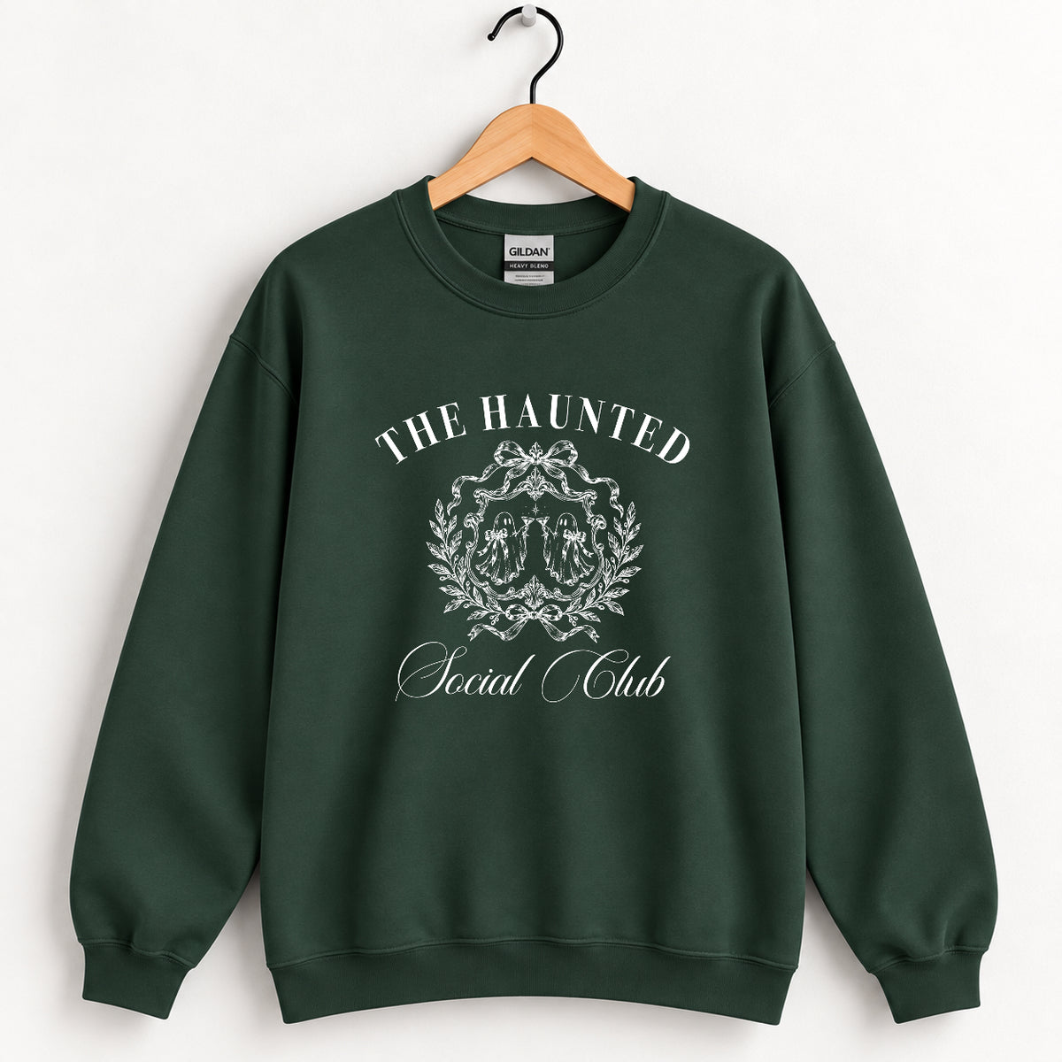 The Haunted Social Club crewneck sweatshirt in Forest Green on a wooden hanger