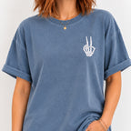 Woman wearing the peace sign skeleton hand embroidered tee in Blue Jean