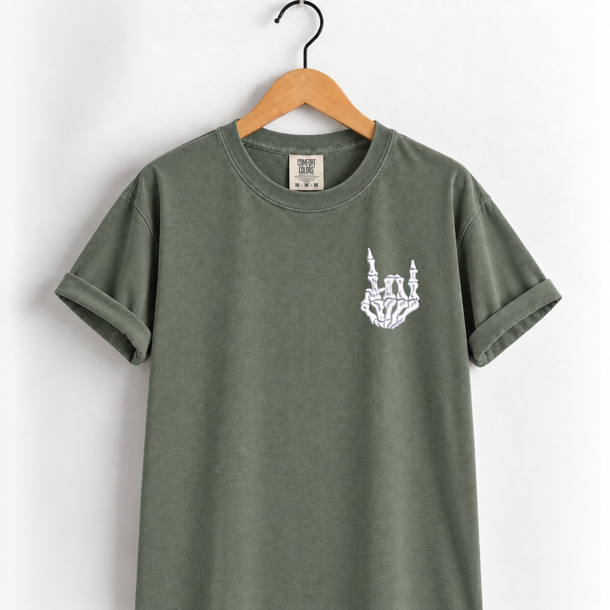 Rock on skeleton hand embroidered tee in Moss on a wooden hanger