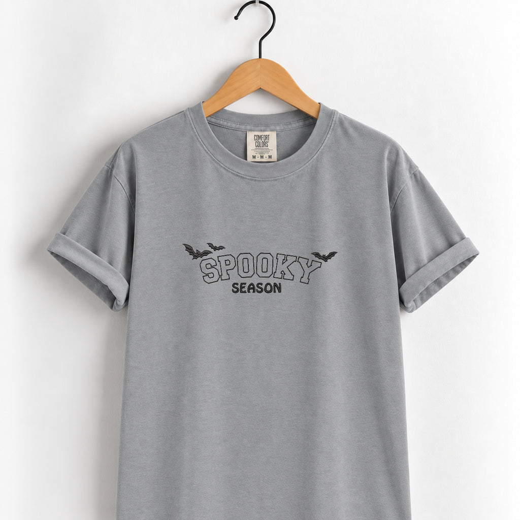 Spooky Season embroidered tee in Grey on a wooden hanger