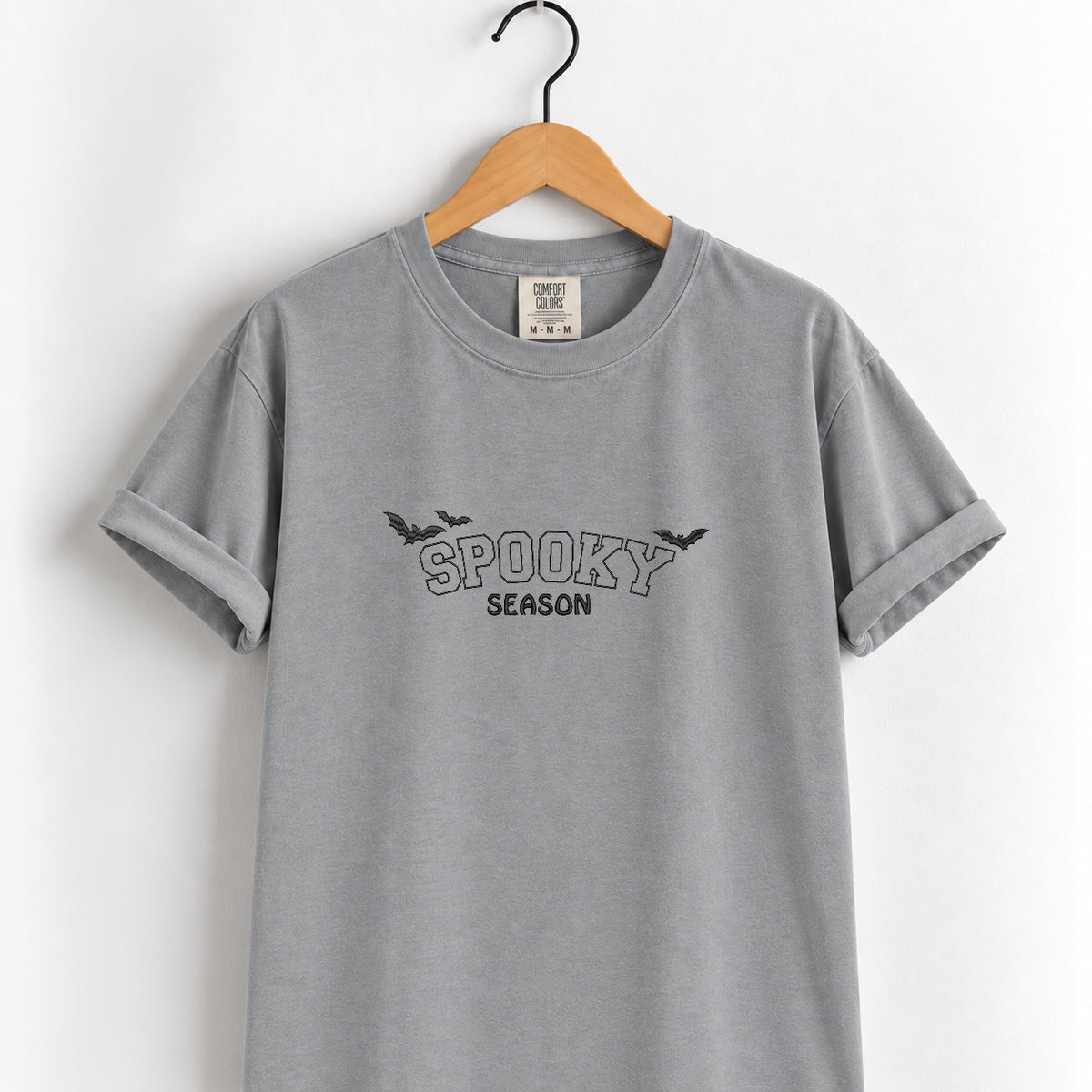 Spooky Season embroidered tee in Grey on a wooden hanger