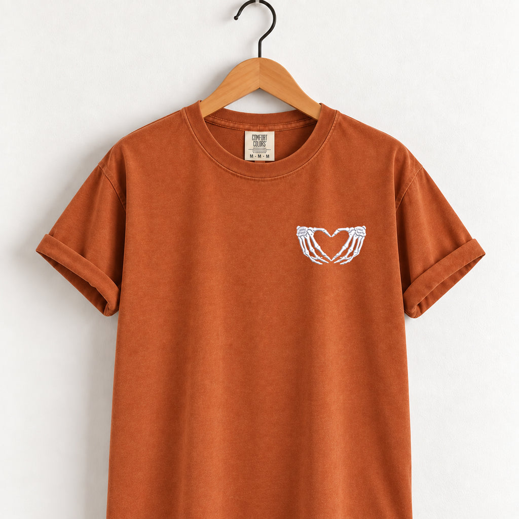 Heart hands skeleton embroidered tee in Yam on a wooden hanger