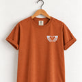 Heart hands skeleton embroidered tee in Yam on a wooden hanger