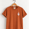 Peace sign skeleton hand embroidered tee in Yam on a wooden hanger