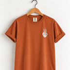 Peace sign skeleton hand embroidered tee in Yam on a wooden hanger