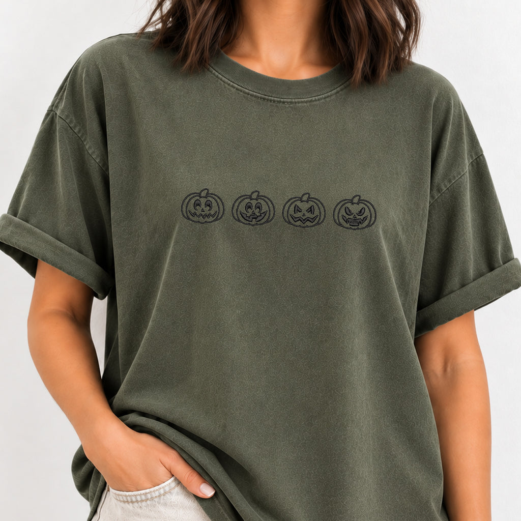 Woman wearing the jack-o-lantern embroidered tee in Moss