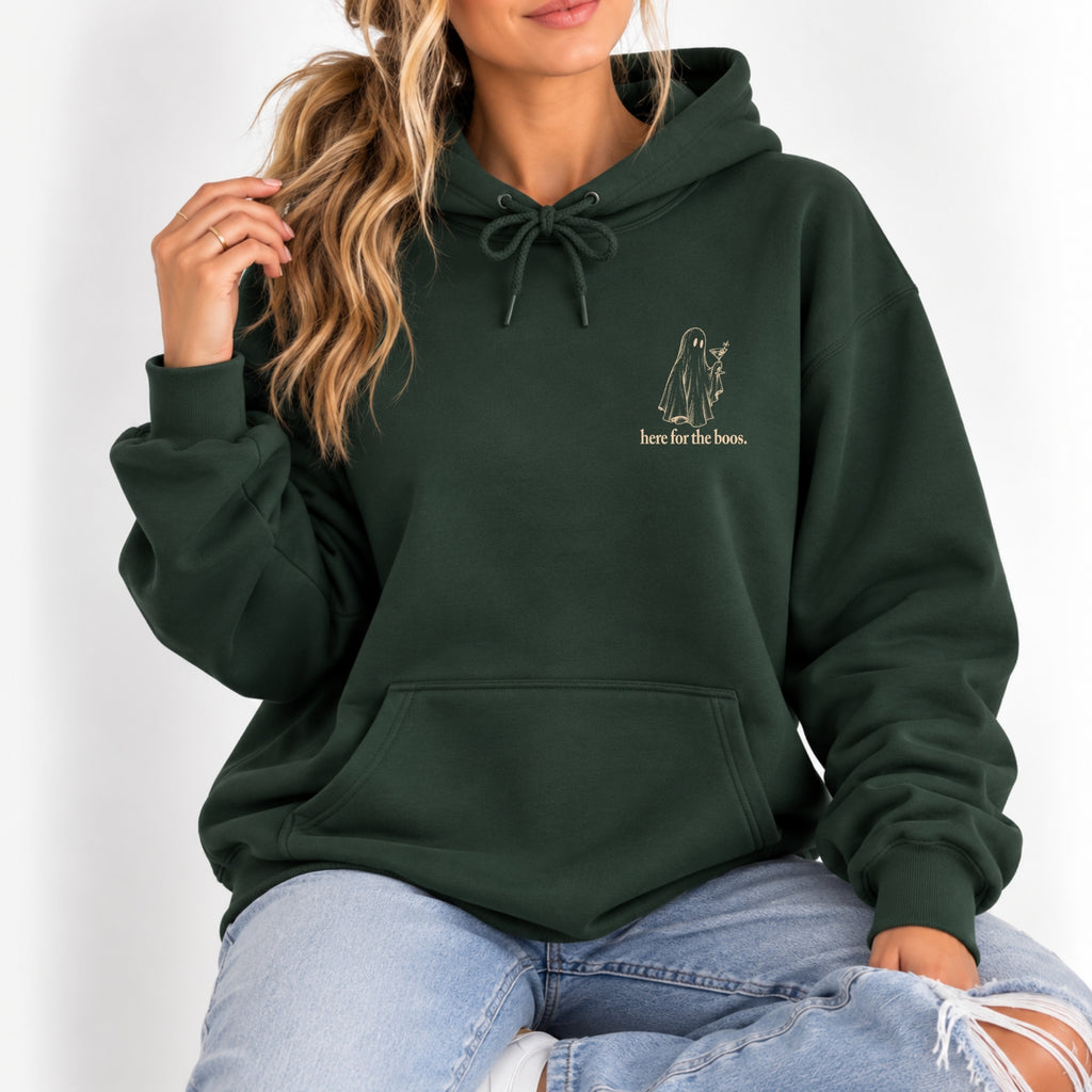 Woman wearing the Here for the Boos hoodie in Forest Green with ripped jeans