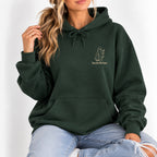 Woman wearing the Here for the Boos hoodie in Forest Green with ripped jeans