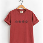 Jack-o-lantern embroidered tee in Chili on a wooden hanger